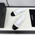 CHANEL BOW MULE IN WHITE FABRIC AND BLACK CALFSKIN